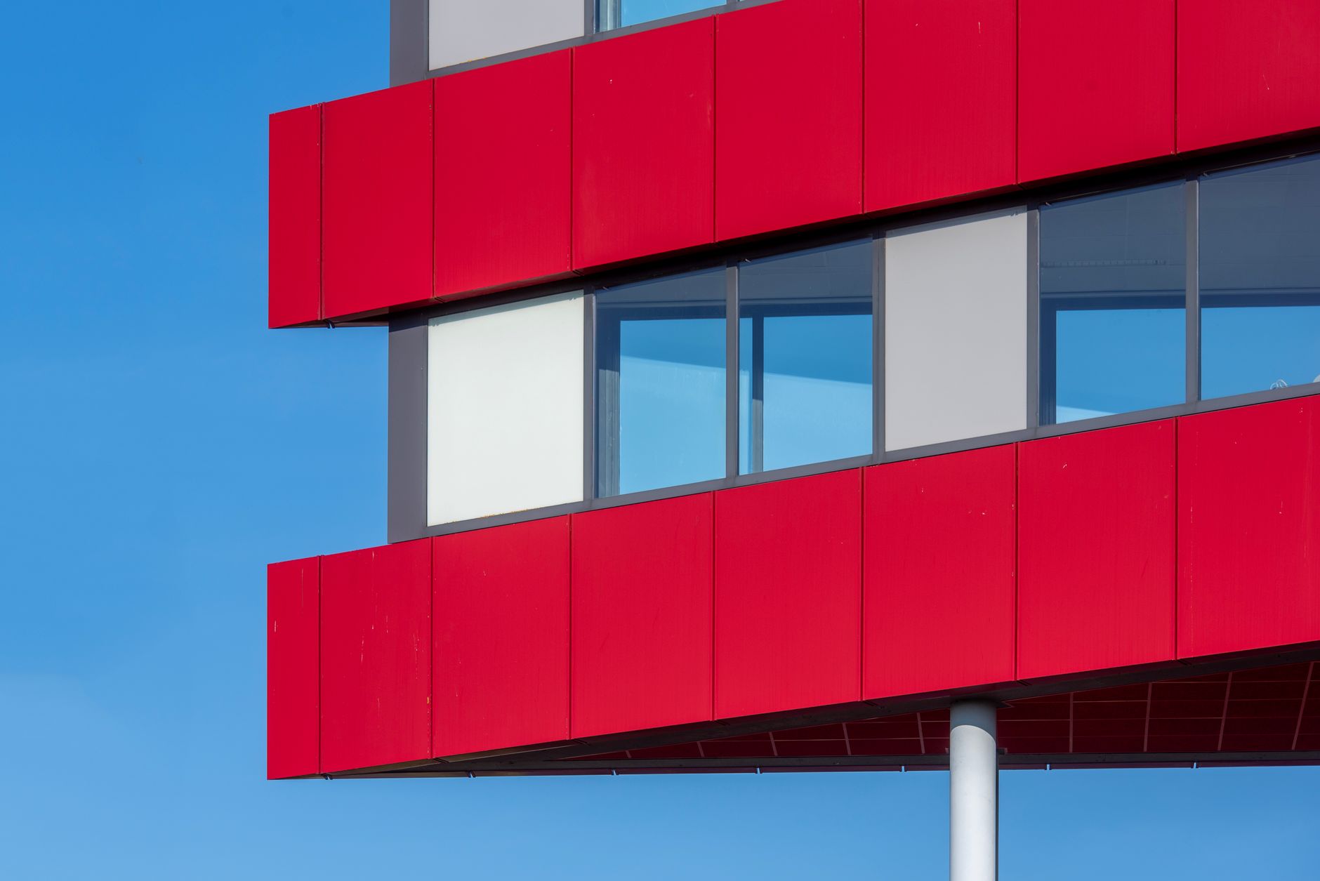 Exterior of a modern red-panelled building