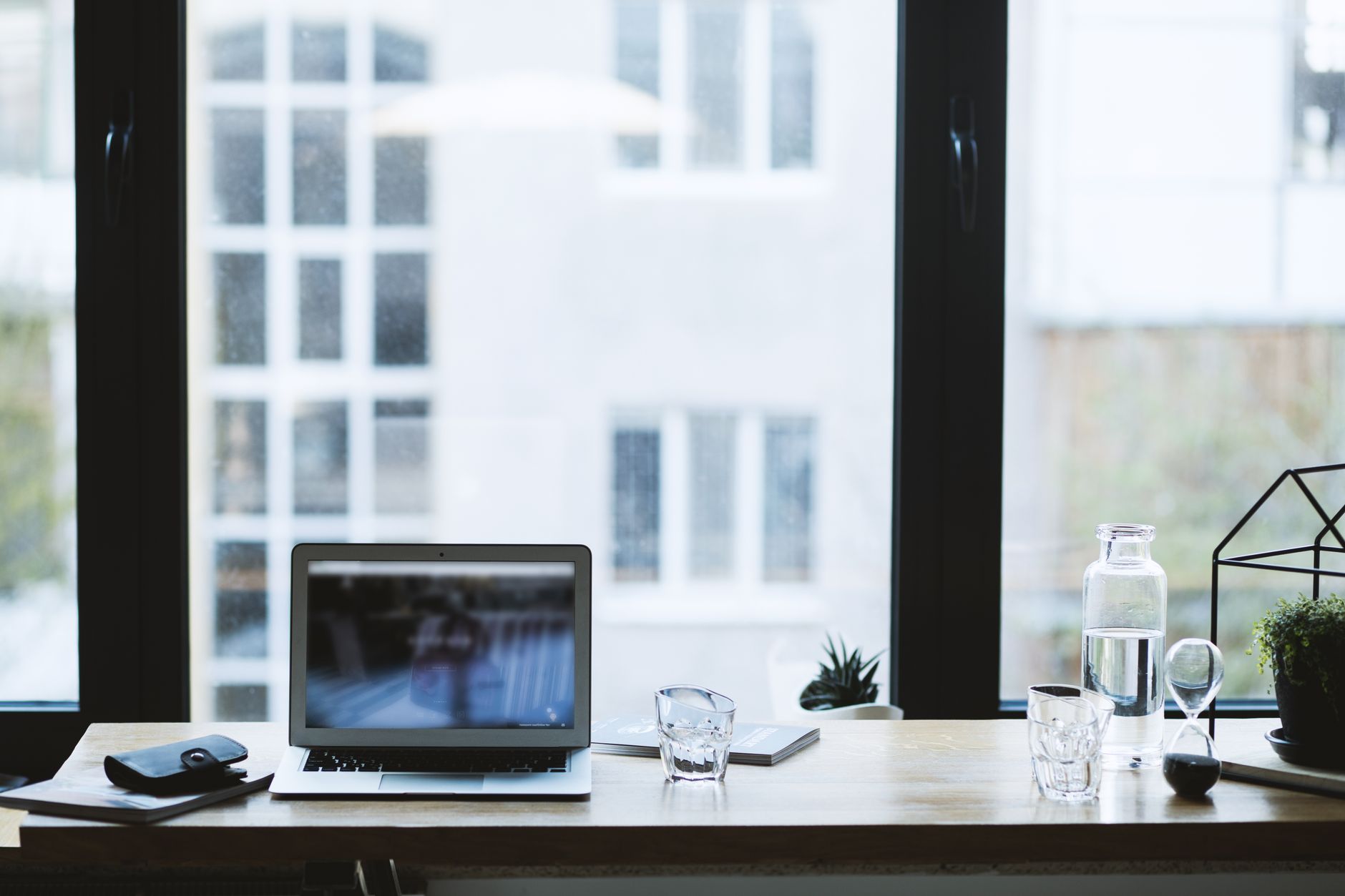 Laptop on a desk by a window
