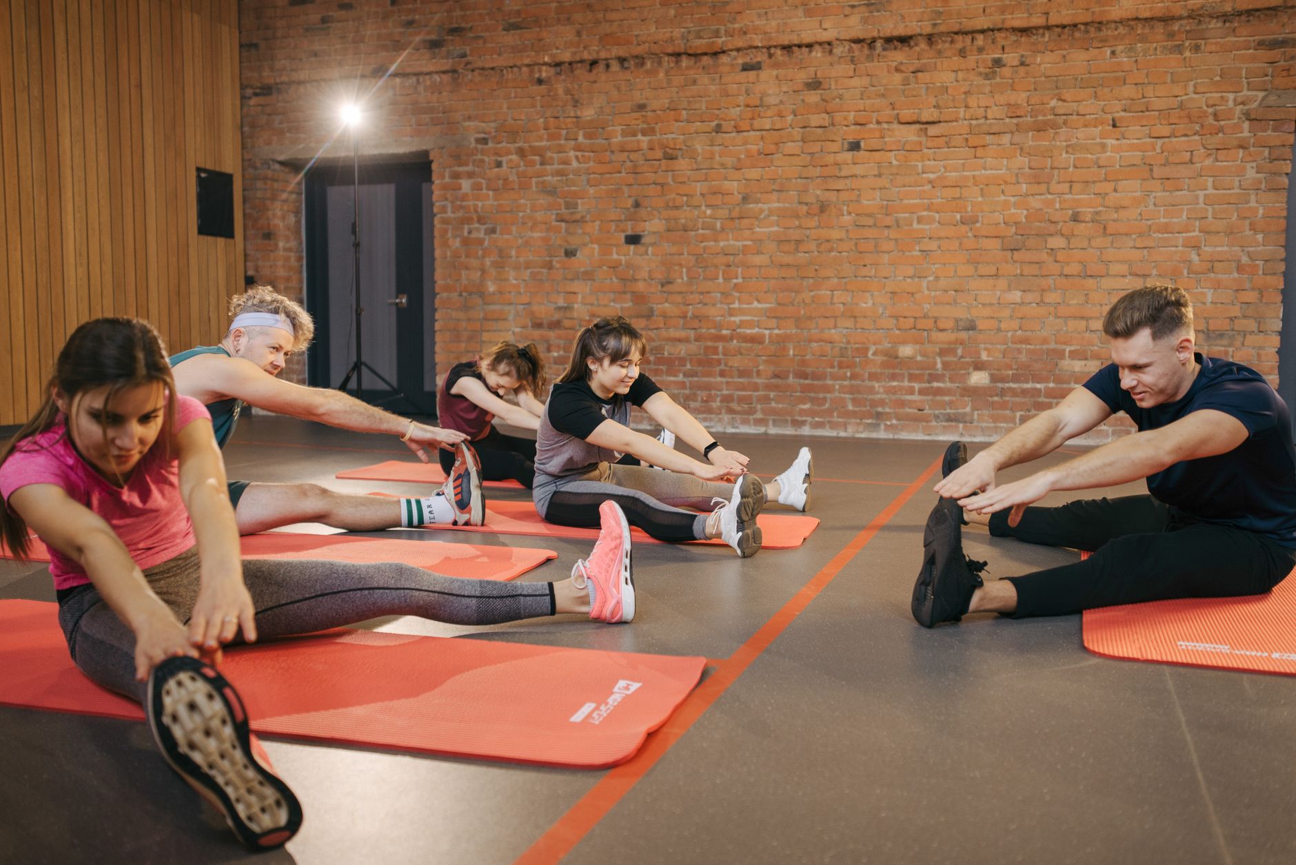 Group stretching on orange mats